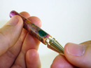 Screwing pen tip into bottom tube