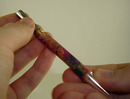 Screwing pen mechanism into bottom tube