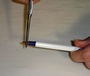 Using pliers to take apart a Bic pen