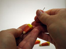 Insert eyepins into candy corns