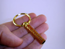 Cap with keyring, pressed into tube