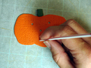 Poking holes in pumpkin with straw